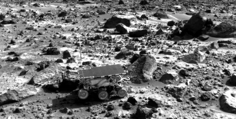 The Sojourner rover beside rocks on Mars during the Mars Pathfinder mission